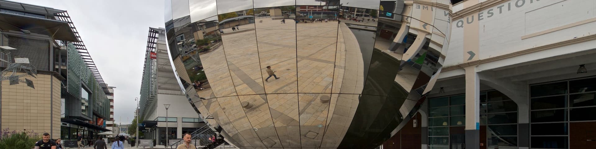 Millennium Square which includes street scenes and outdoor art as well as a small group of people