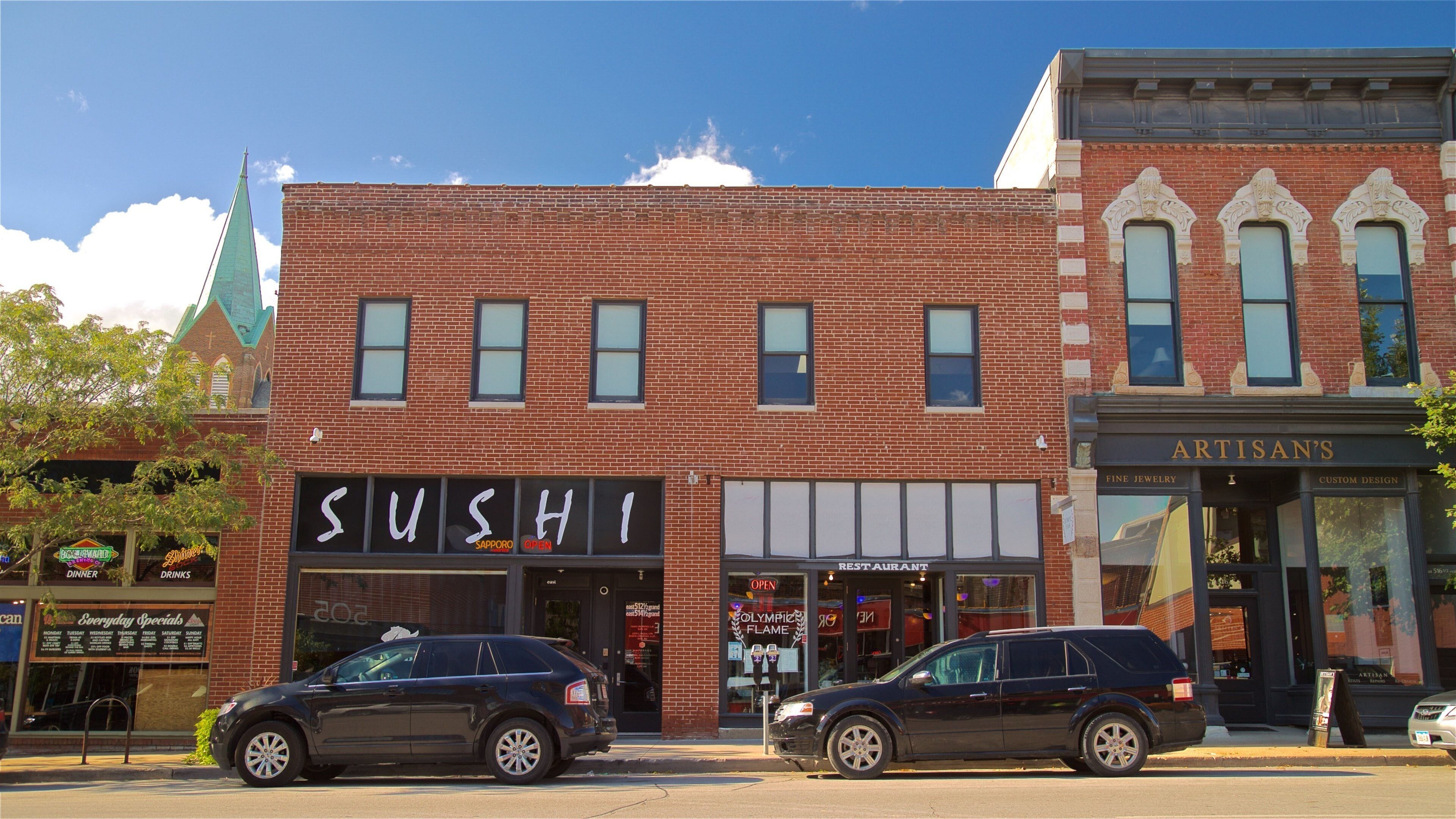 A brick building with a sushi restaurant and an artisan's shop.