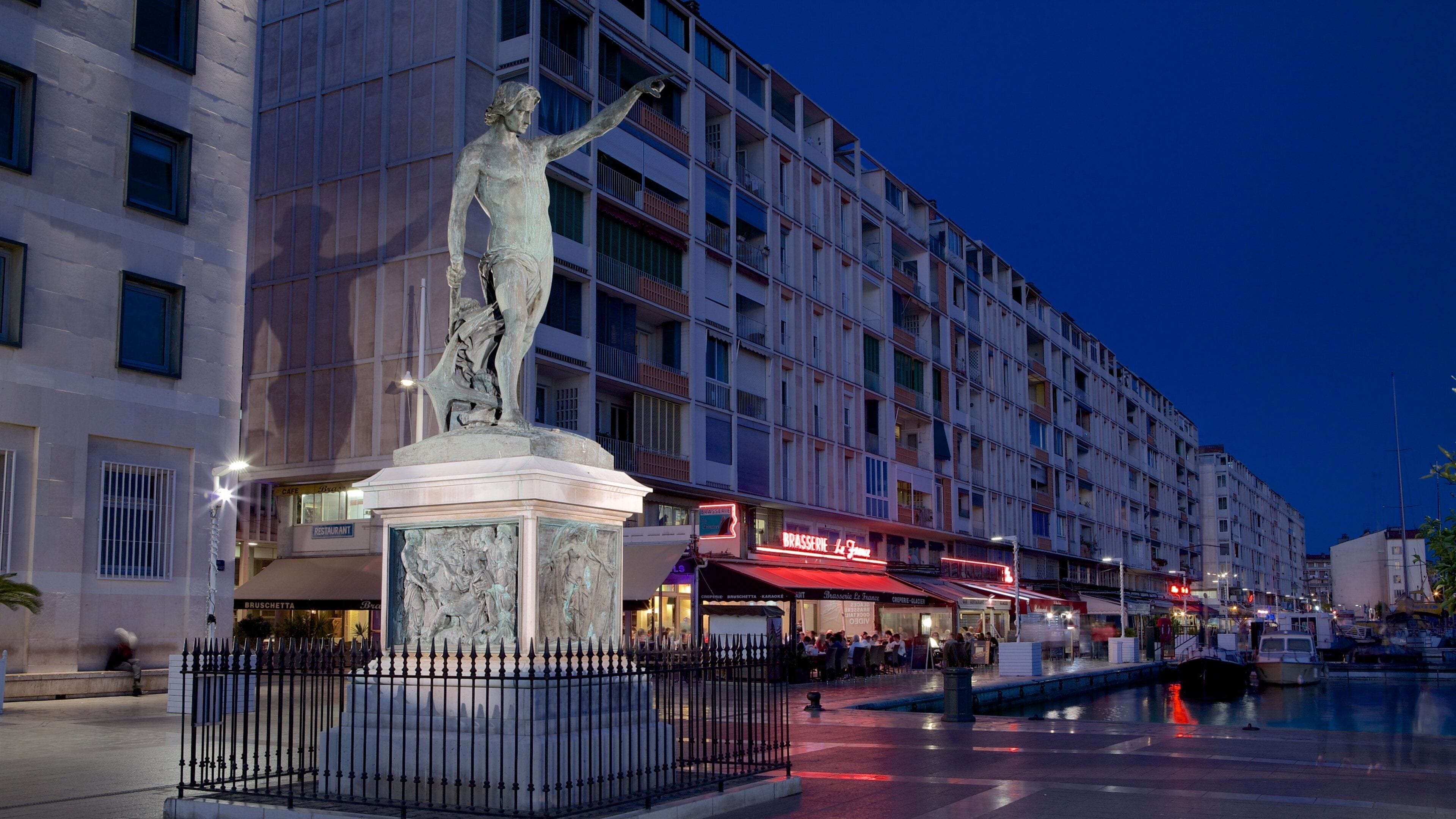 Toulon Marina featuring night scenes, a square or plaza and a statue or sculpture