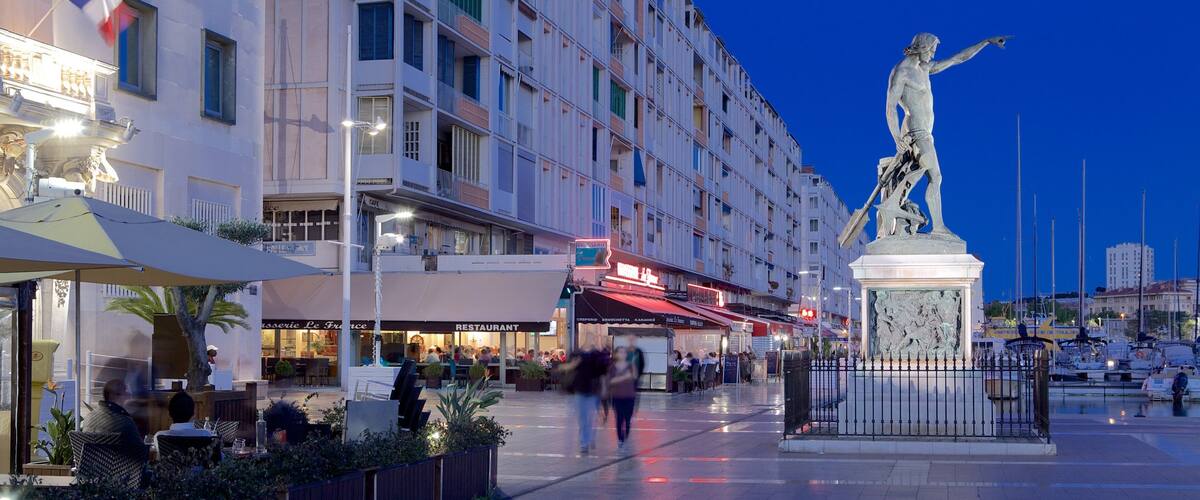 Toulon Marina featuring night scenes, a square or plaza and a statue or sculpture