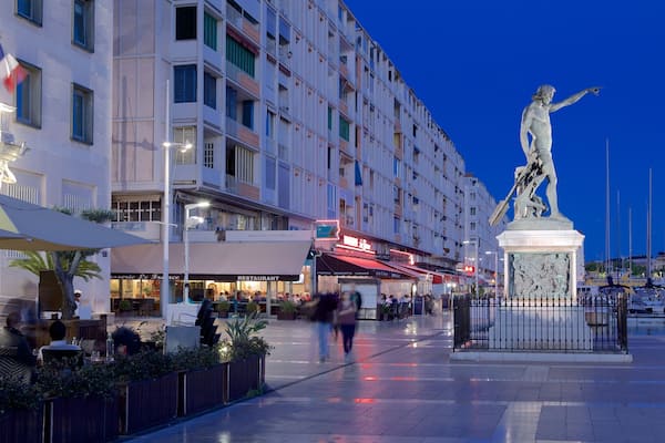 Toulon Marina featuring night scenes, a square or plaza and a statue or sculpture