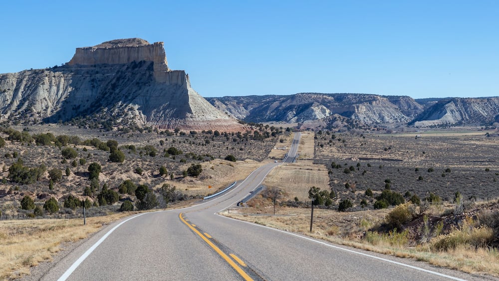 Scenic road in the desert during a vibrant sunny day. Taken on Route 12 near Cannonville, Utah, United States of America.