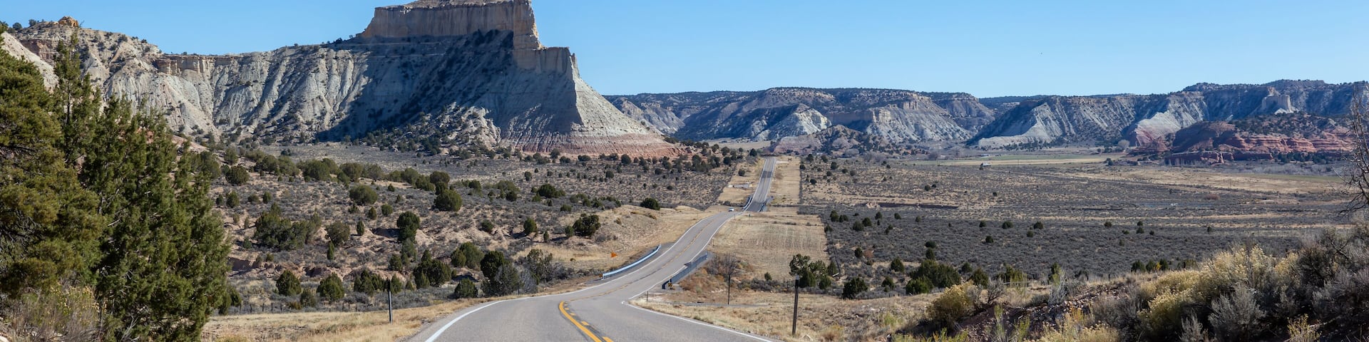 Scenic road in the desert during a vibrant sunny day. Taken on Route 12 near Cannonville, Utah, United States of America.