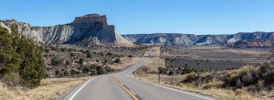 Scenic road in the desert during a vibrant sunny day. Taken on Route 12 near Cannonville, Utah, United States of America.