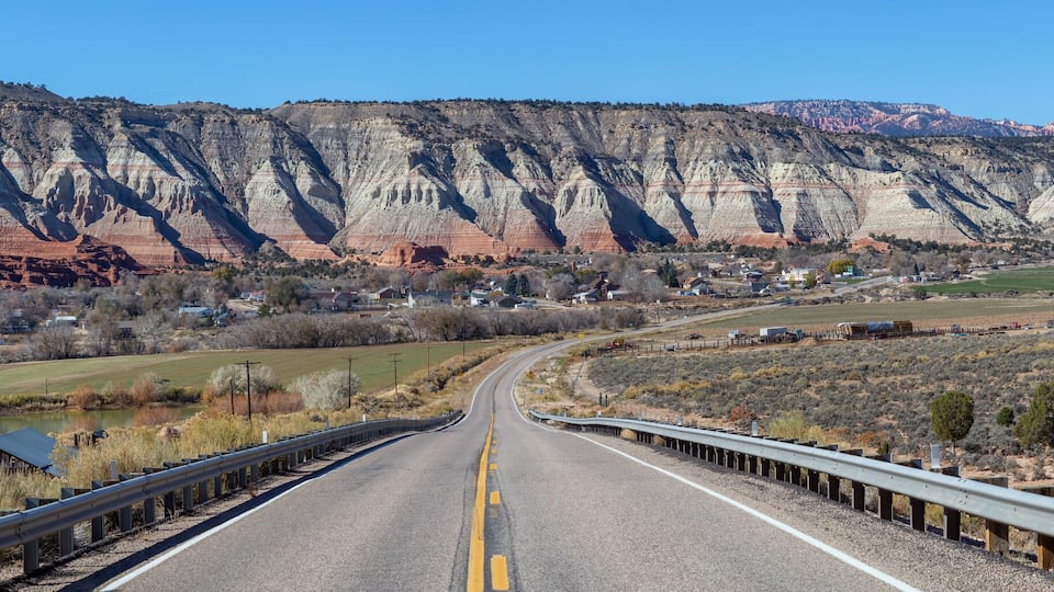 Scenic road in the desert during a vibrant sunny day. Taken on Route 12 near Cannonville, Utah, United States of America.