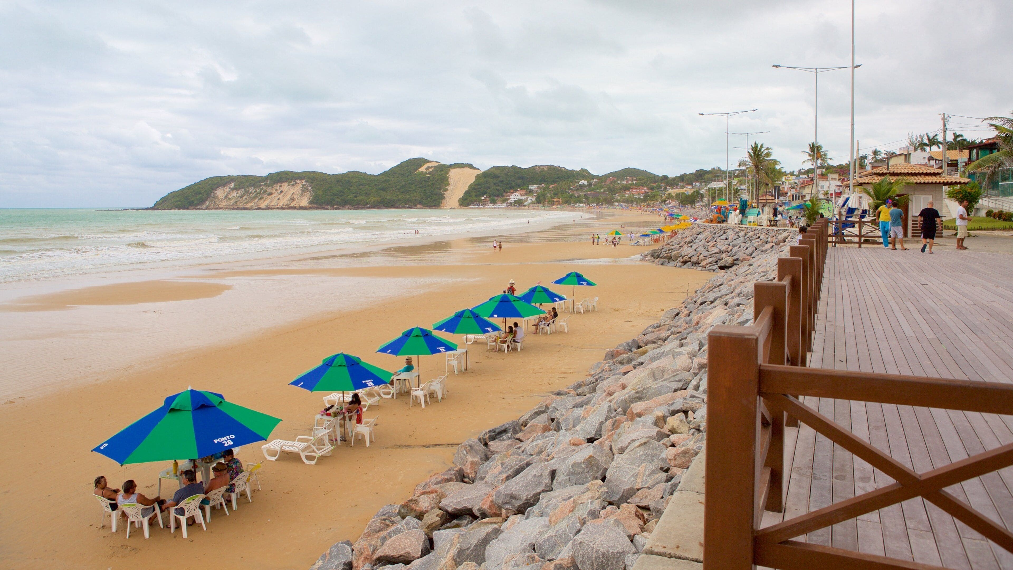 Ponta Negra strand fasiliteter samt kyst og sandstrand i tillegg til en liten gruppe med mennesker