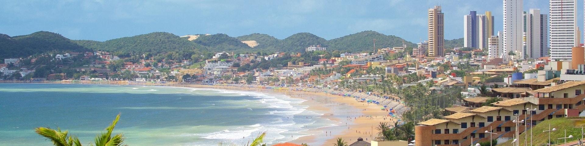 Ponta Negra Beach which includes a coastal town, a skyscraper and a beach