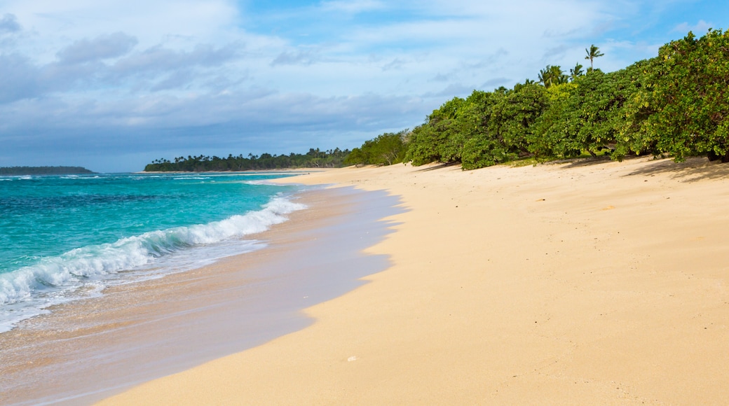 Shore of an azure, turquoise, blue lagoon. Waves, surf, swash at a remote empty idyllic sandy beach on Foa island, Haapai (Haʻapai or Ha'apai) group, Tonga, Oceania, South Pacific Ocean. Near Lifuka.