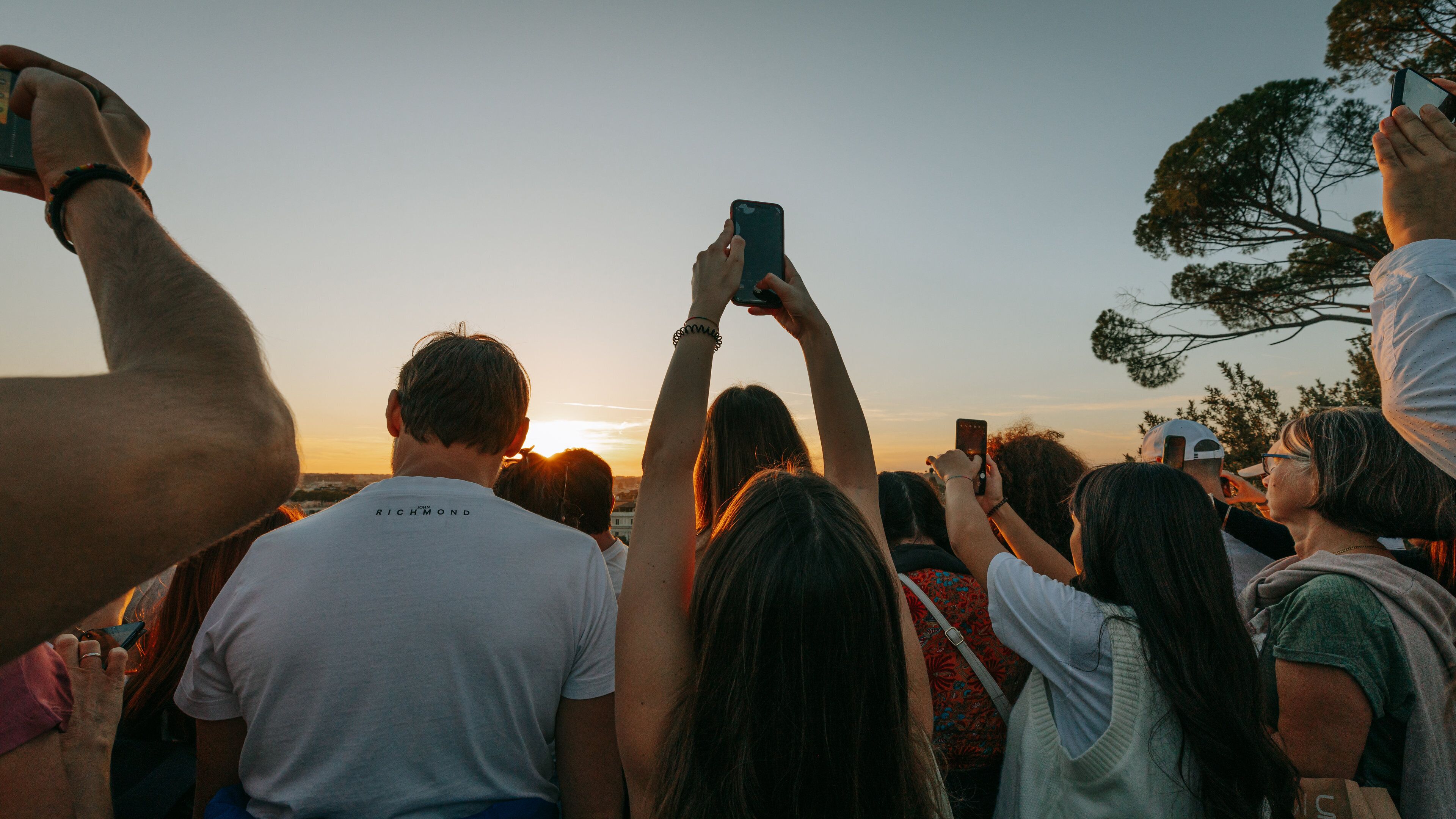 Pincio Terrace showing views and a sunset as well as a small group of people