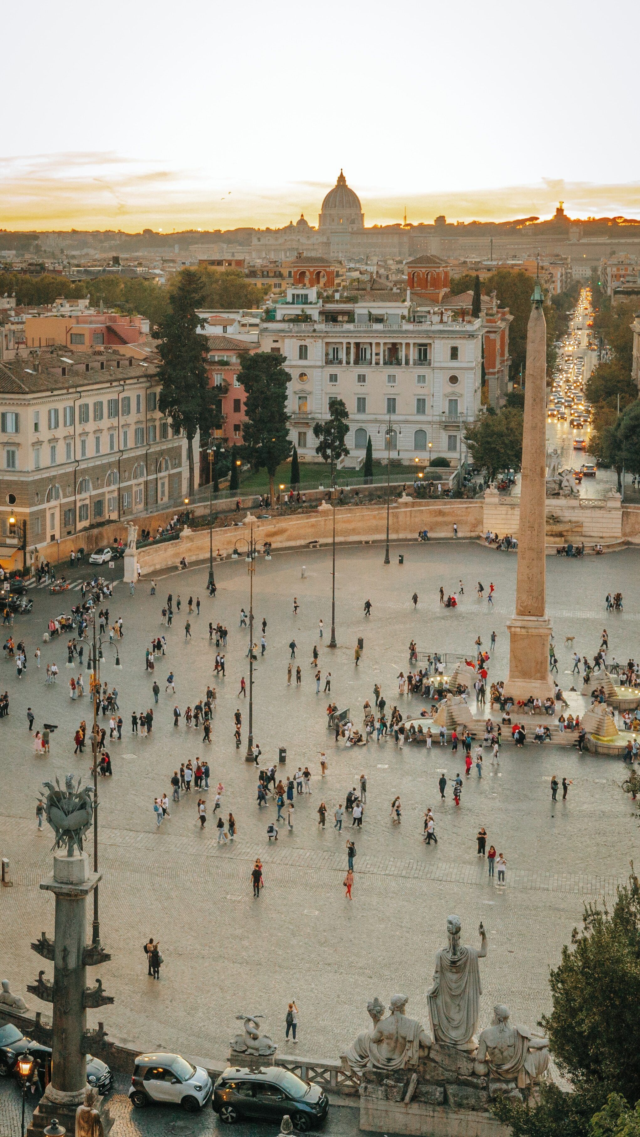 Stunning sunset view from Pincio Terrace overlooking the historic centre of Rome with vibrant activity in the streets below