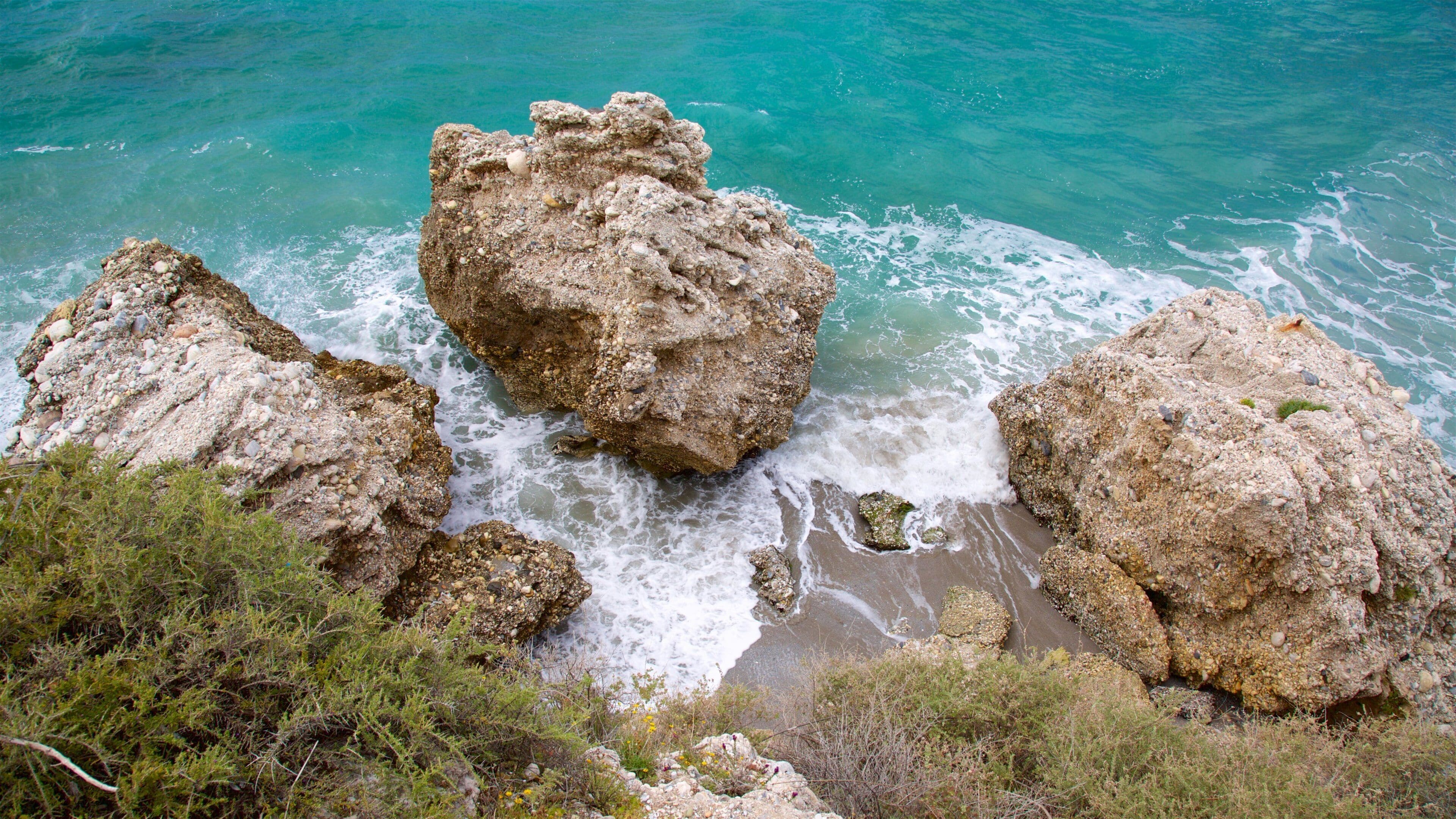 Rocky coastal landscape with turquoise sea.