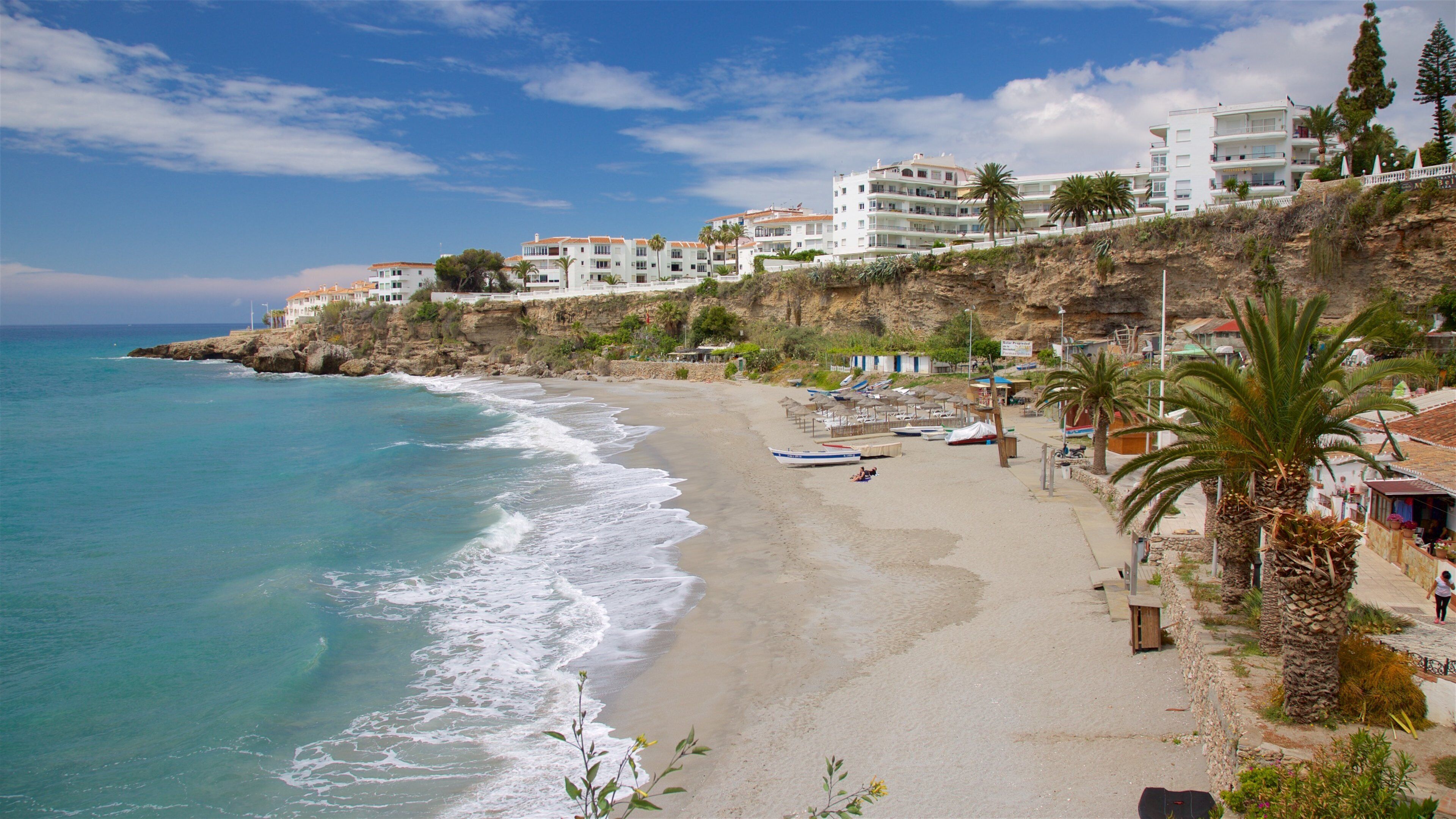 Salon Beach showing a sandy beach, a bay or harbor and a coastal town
