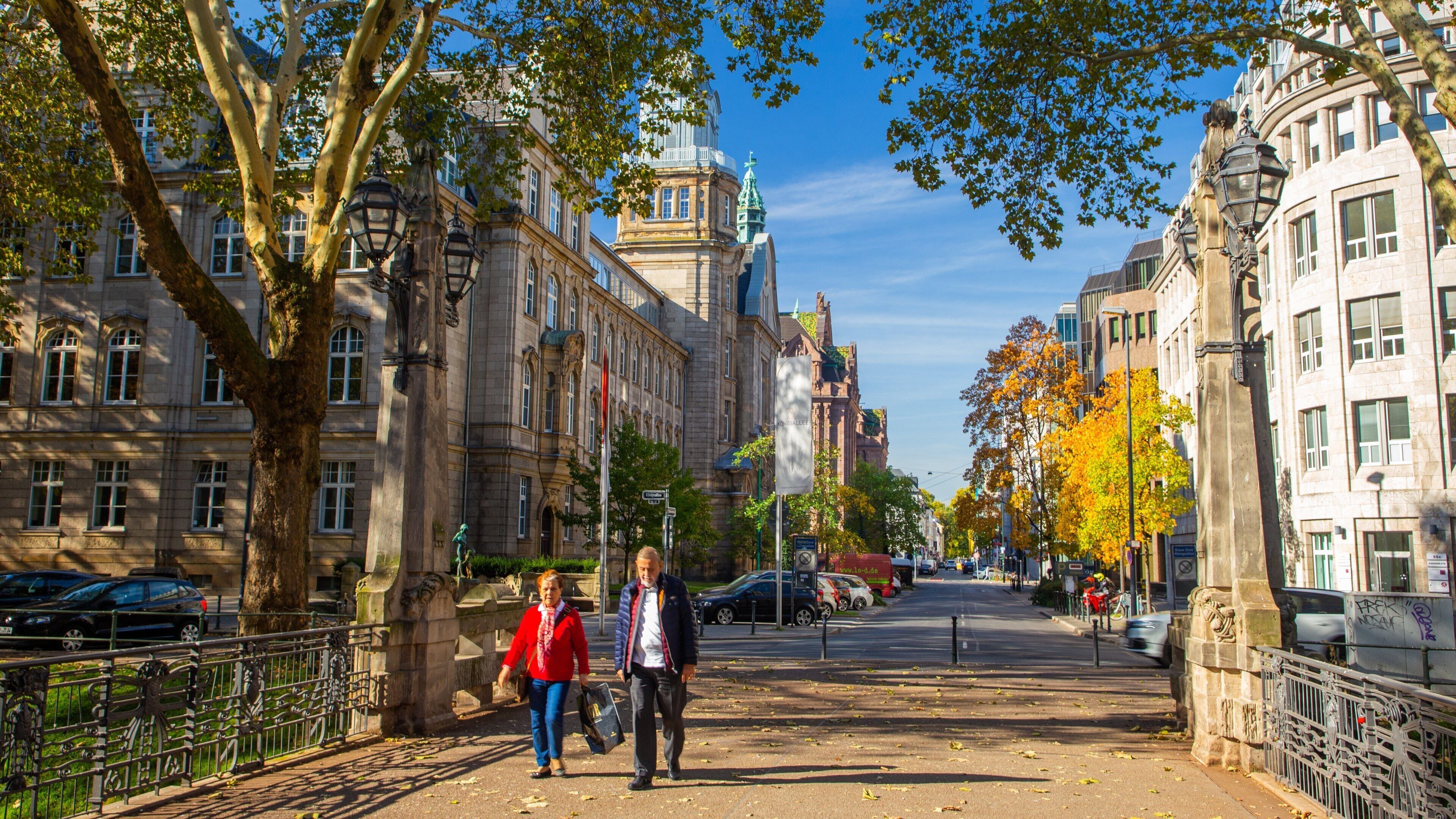 Düsseldorf which includes street scenes and a city as well as a couple
