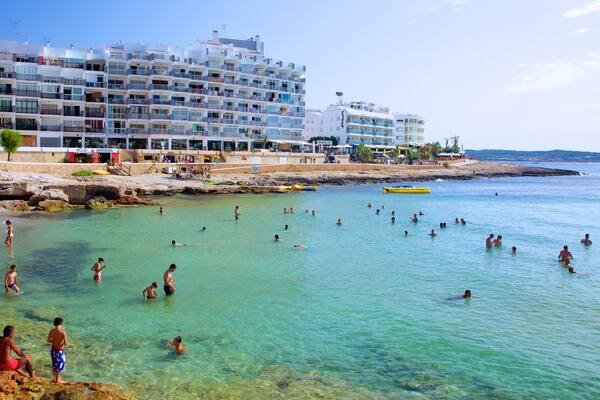 Calo des Moro Beach which includes general coastal views, a coastal town and swimming