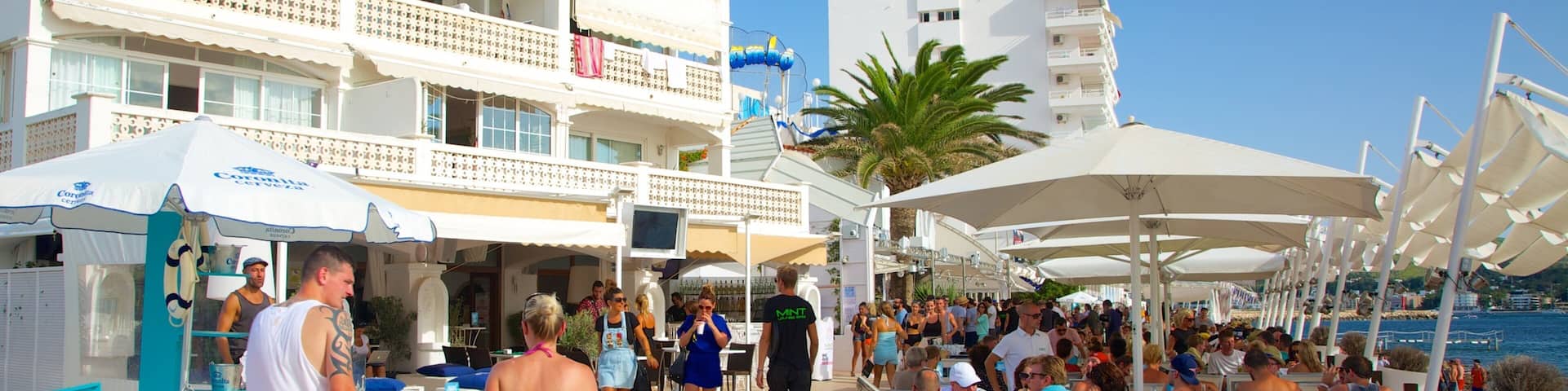 Calo des Moro Beach which includes a hotel, a bay or harbor and outdoor eating