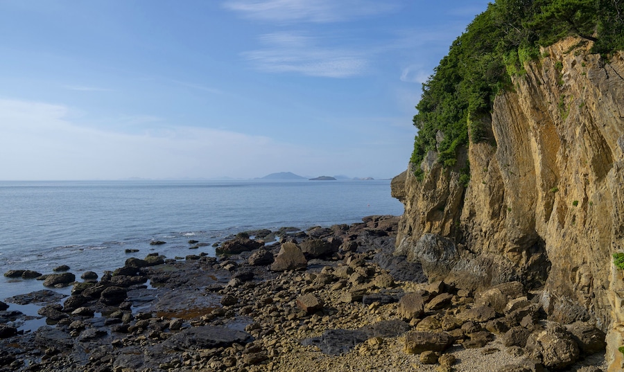 Byeonsan-myeon, Buan-gun, Jeollabuk-do, South Korea - July 11, 2018: Summer view of rocks at low tide at Chaeseokgang Cliff of Byeonsan Peninsula against horizon