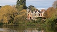 Bletchley Park featuring a pond and a house