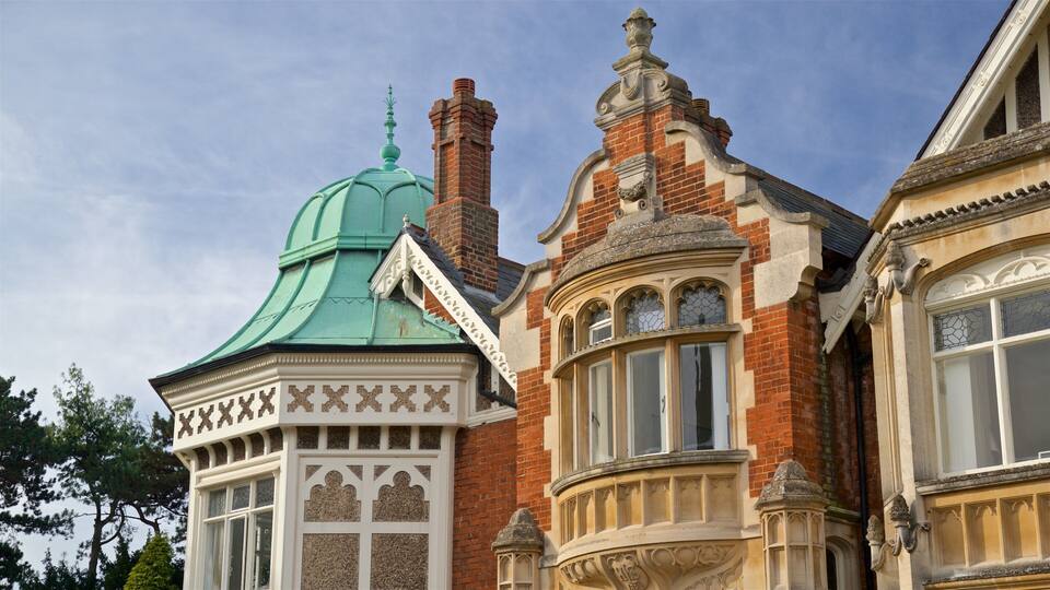 A historic building with a green dome, ornate windows, and detailed brickwork.