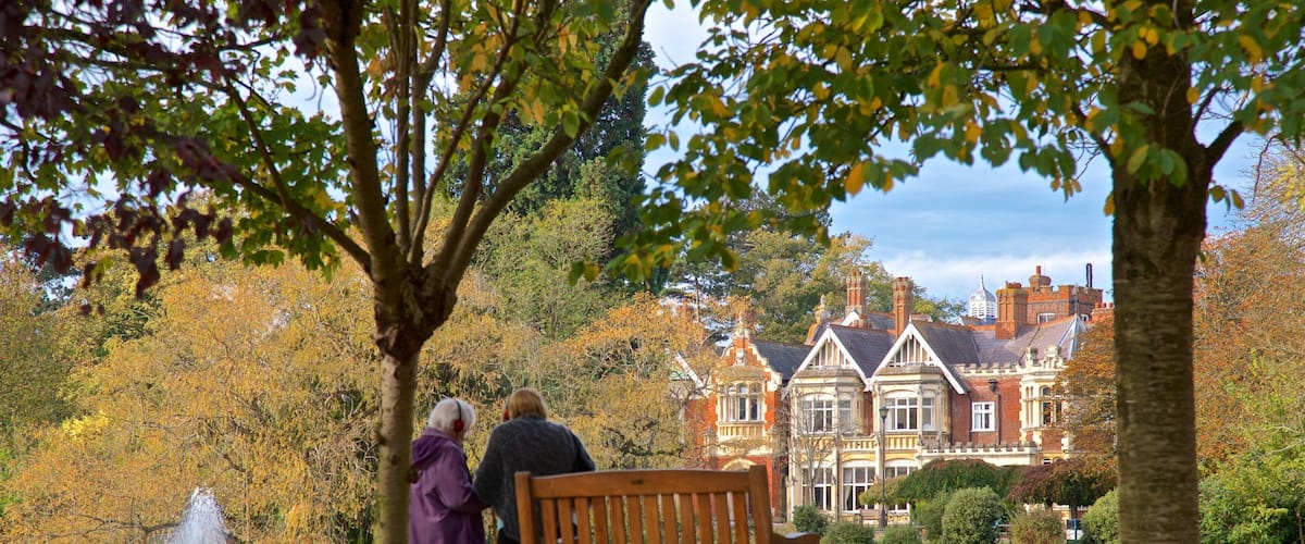 Bletchley Park showing a park and a pond as well as a couple