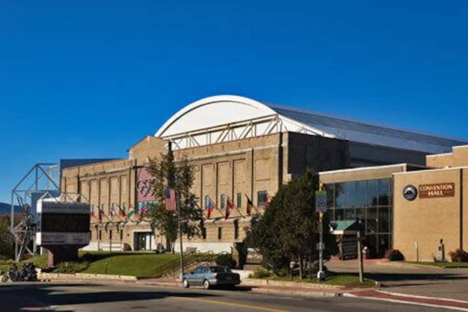 A large convention center with a prominent dome roof and multiple flags.