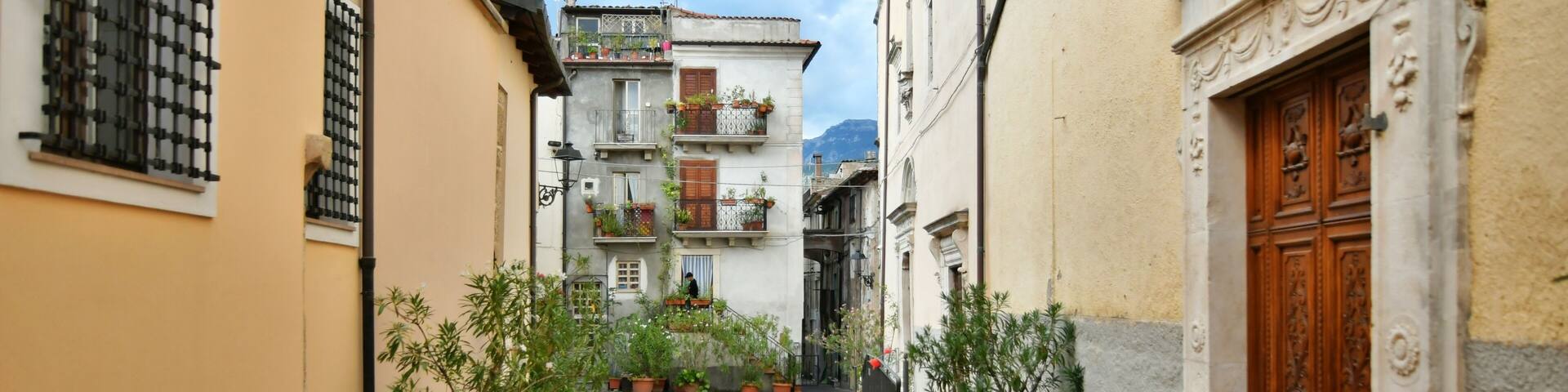 A narrow street between the old stone houses of Pratola Peligna, a medieval village in the Abruzzo region of Italy.
