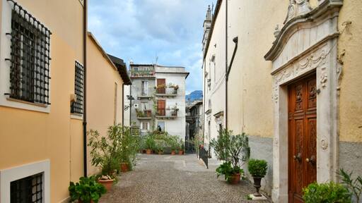 A narrow street between the old stone houses of Pratola Peligna, a medieval village in the Abruzzo region of Italy.