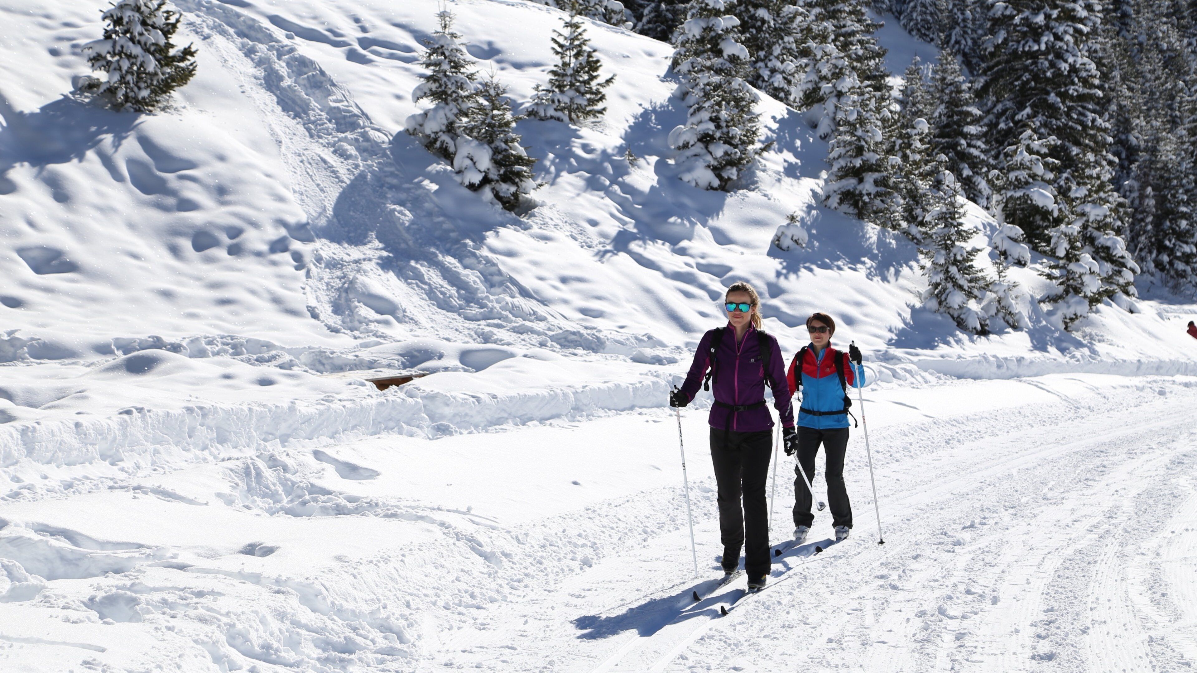 Meribel Ski Resort showing snow skiing and snow as well as a small group of people