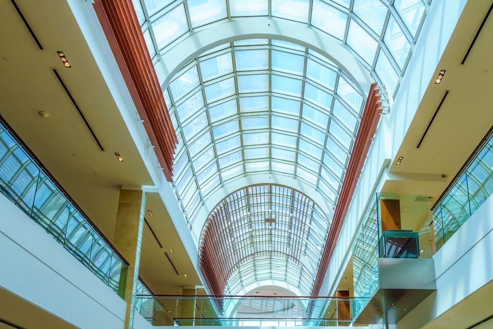 A modern interior with a glass ceiling and multiple levels.