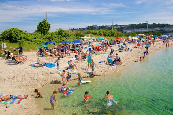Ogunquit Beach which includes a sandy beach and general coastal views as well as a large group of people