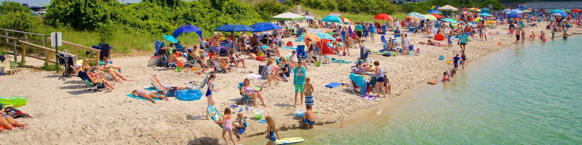 Ogunquit Beach which includes a sandy beach and general coastal views as well as a large group of people