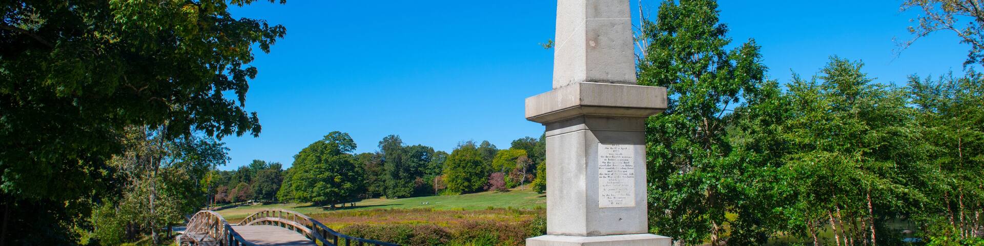Historic Memorial obelisk in Old North Bridge park in Minute Man National Historical Park, Concord, Massachusetts MA, USA.