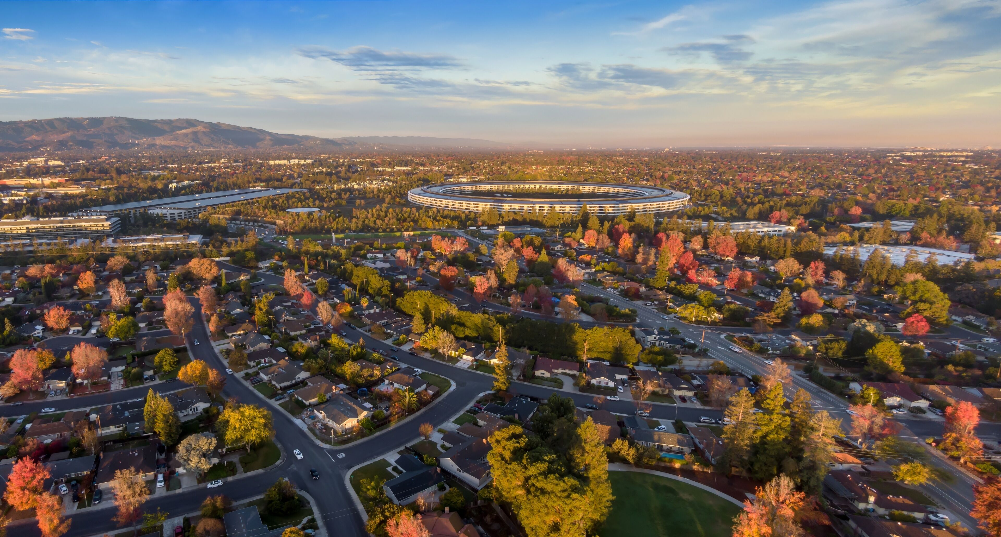 Aerial view of Apple Park, the corporate headquarters of Apple, surrounded by residential neighborhoods in  Santa Clara, California, USA