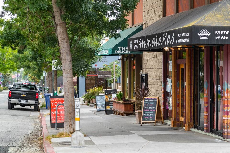 A storefront with a sign reading "Taste of the Himalayas" and "Fine Nepalese & Indian Cuisine".