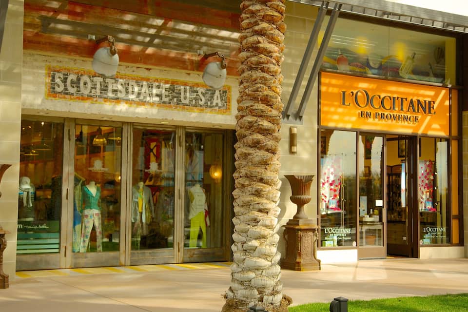 Storefronts with signs reading "SCOTISDALE USA" and "L'OCCITANE EN PROVENCE".