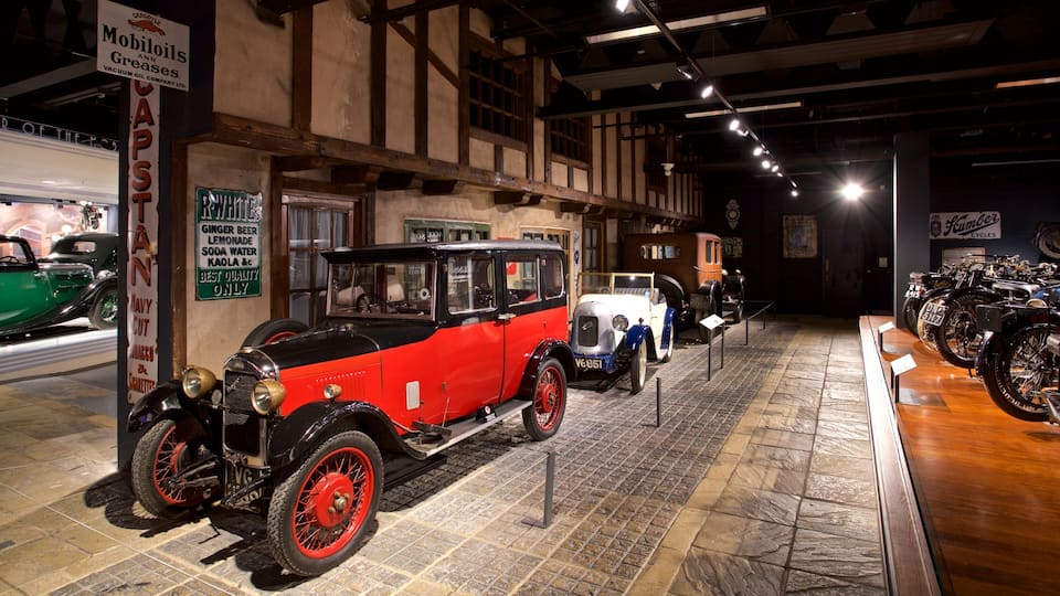 A vintage car exhibition with a red car prominently displayed.