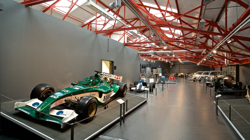 A museum exhibit featuring a Formula 1 car and vintage cars.
