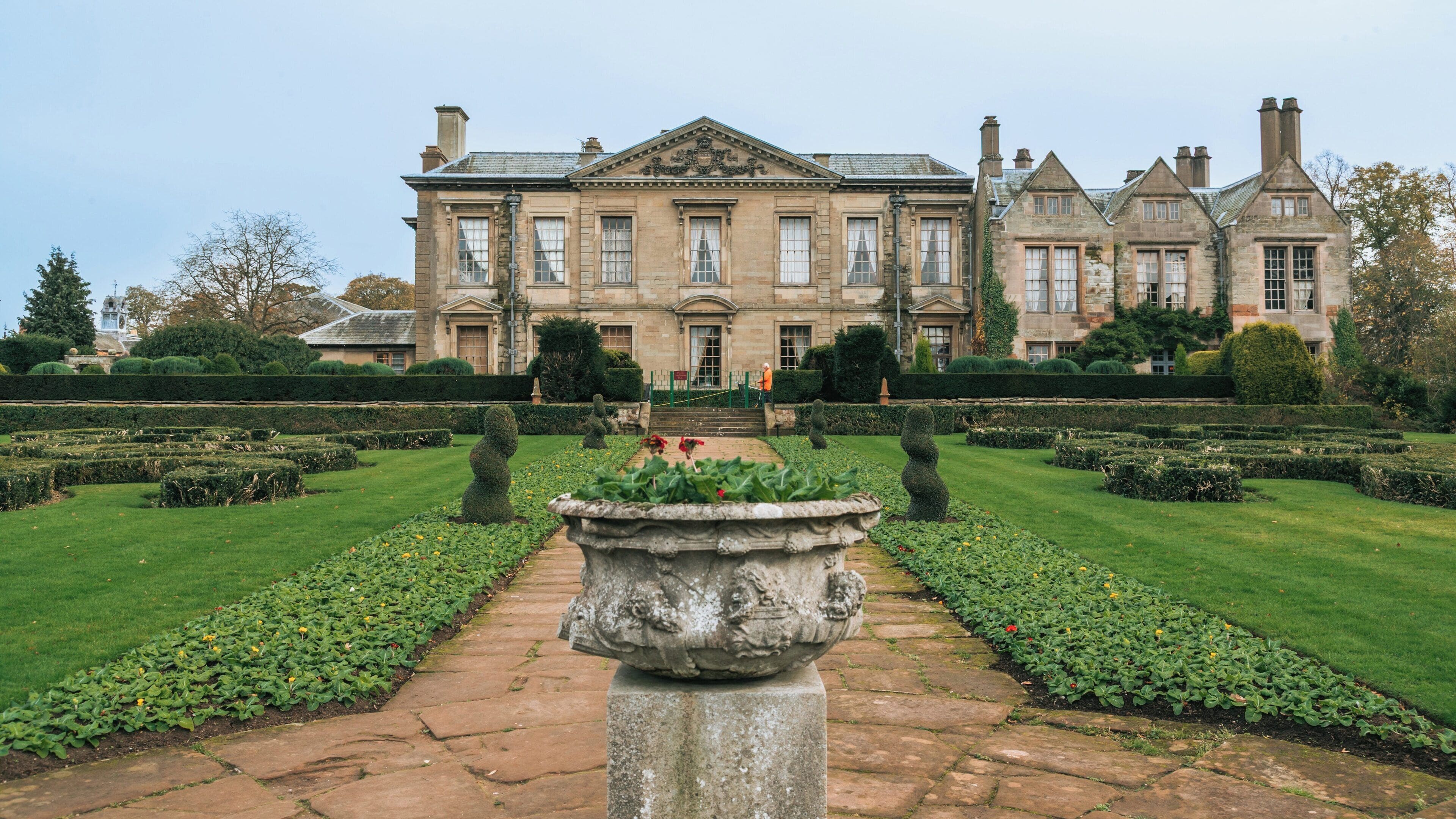 Coombe Abbey Country Park showcases beautiful gardens and classic architecture in Coventry, England during a tranquil afternoon