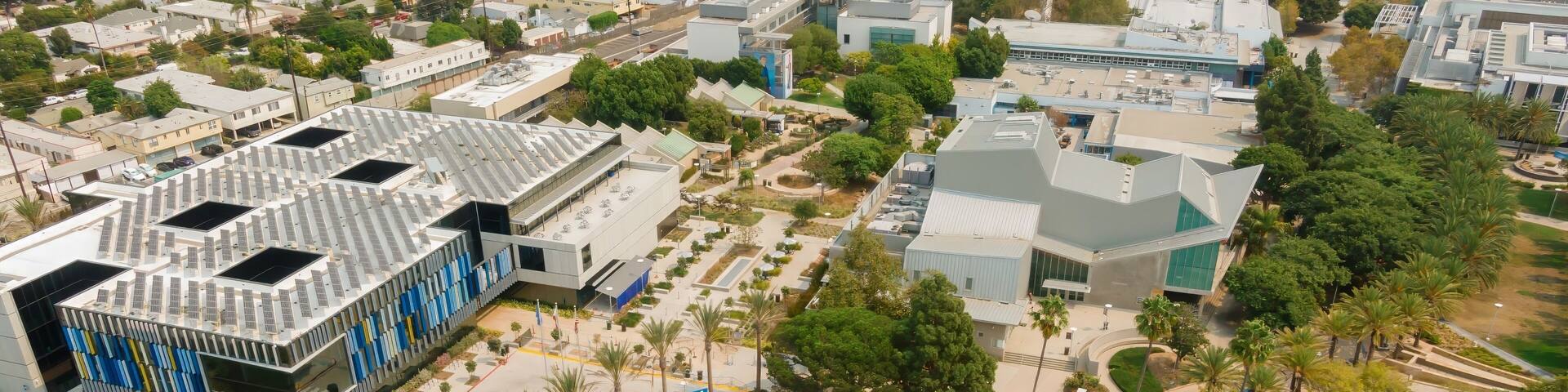 Aerial view of Santa Monica College in California, USA. The photo shows the campus buildings, palm trees, and surrounding neighborhood. The image highlights the college's architecture.