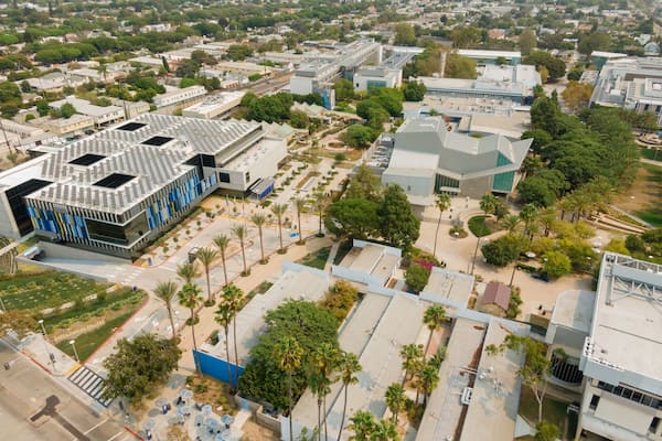 Aerial view of Santa Monica College in California, USA. The photo shows the campus buildings, palm trees, and surrounding neighborhood. The image highlights the college's architecture.