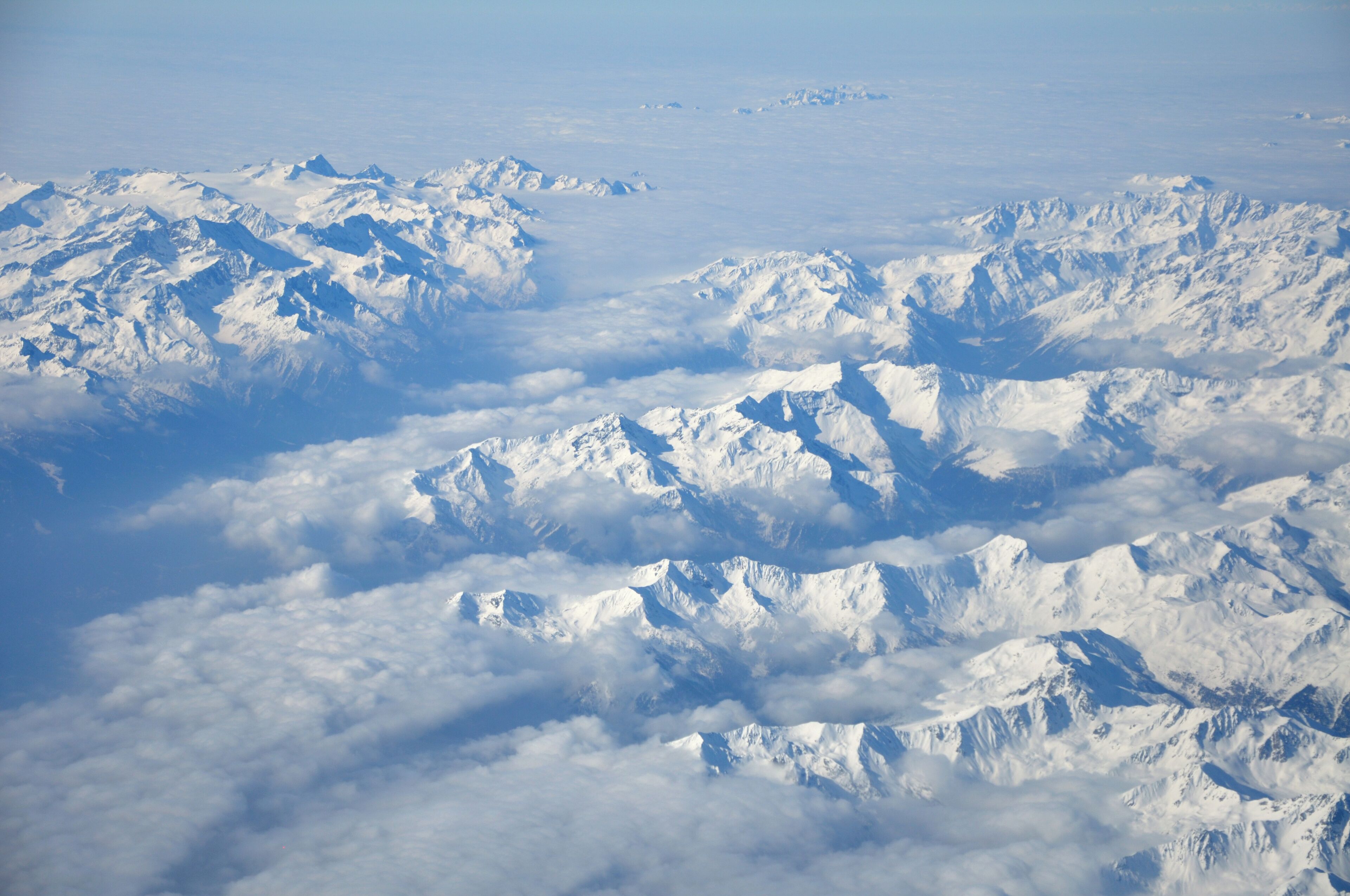 A snow-covered mountain range with peaks and valleys.