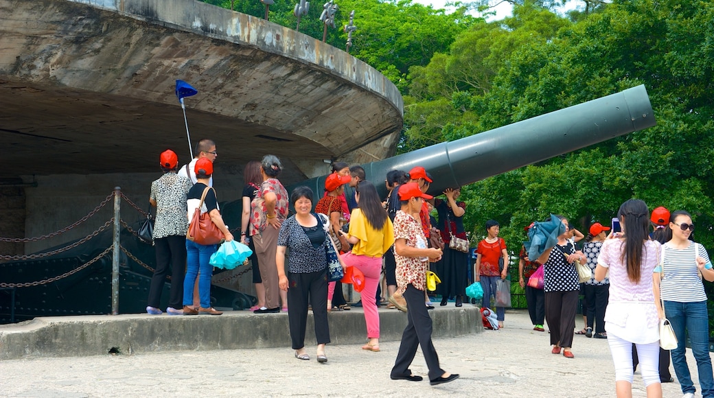 Hulishan Cannon Fort featuring château or palace and military items as well as a large group of people