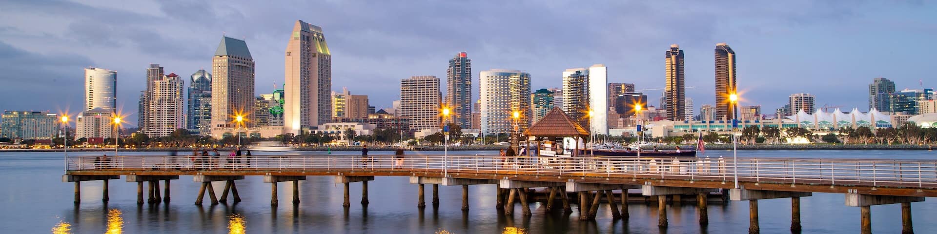 Coronado Ferry Landing featuring a sunset, a city and a beach