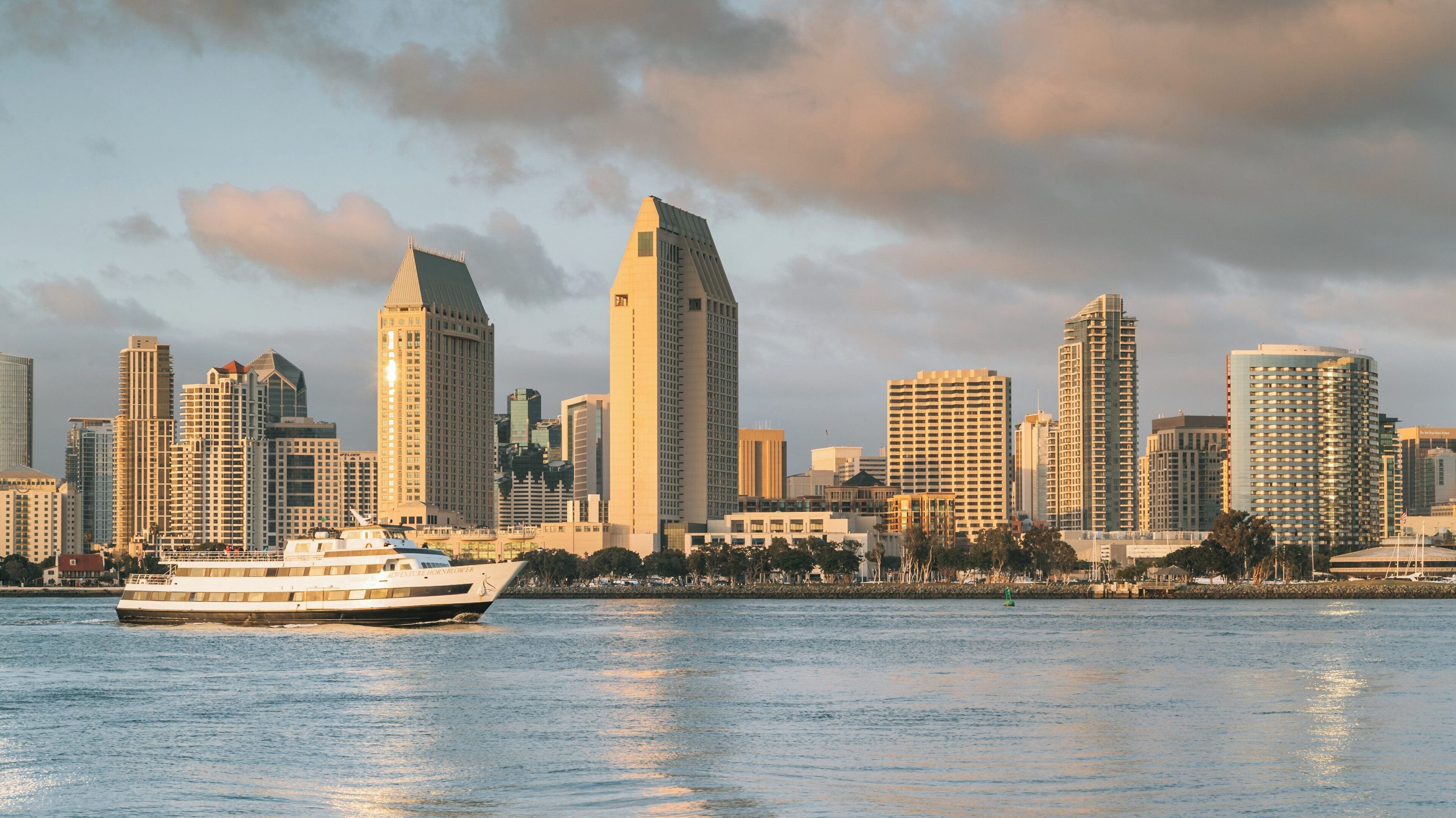 Experience the beauty of Coronado Ferry Landing with stunning views of downtown San Diego and calm waters on a sunny day in California