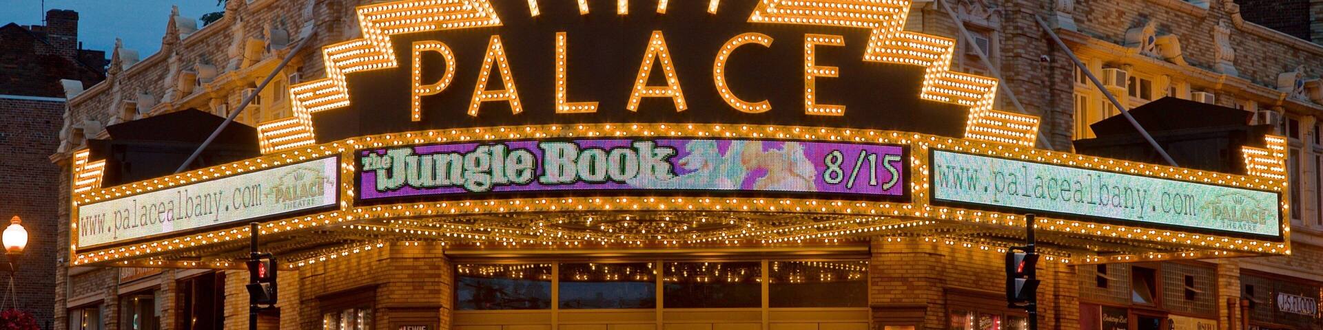 Palace Theater featuring signage and night scenes