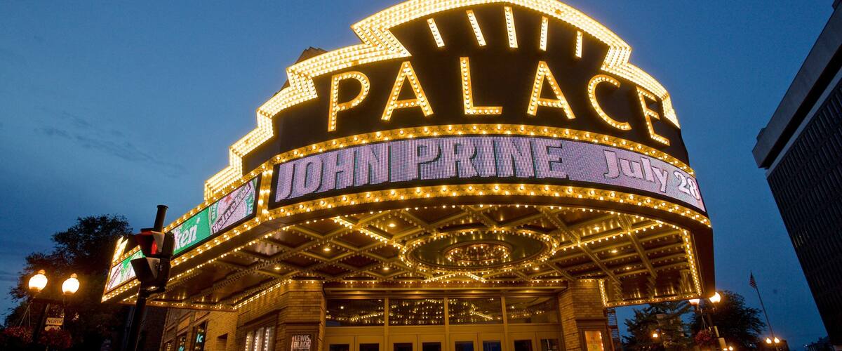 Palace Theater showing signage, heritage architecture and night scenes