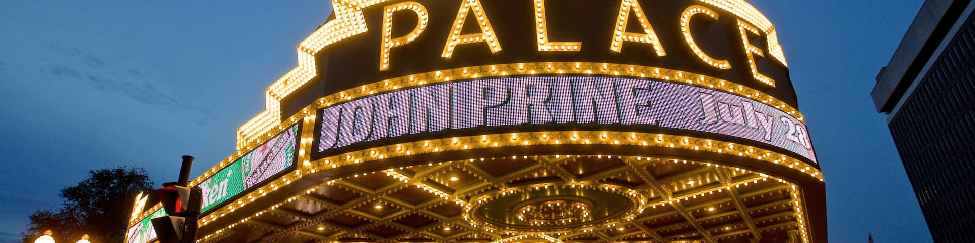 Palace Theater which includes night scenes, signage and heritage architecture