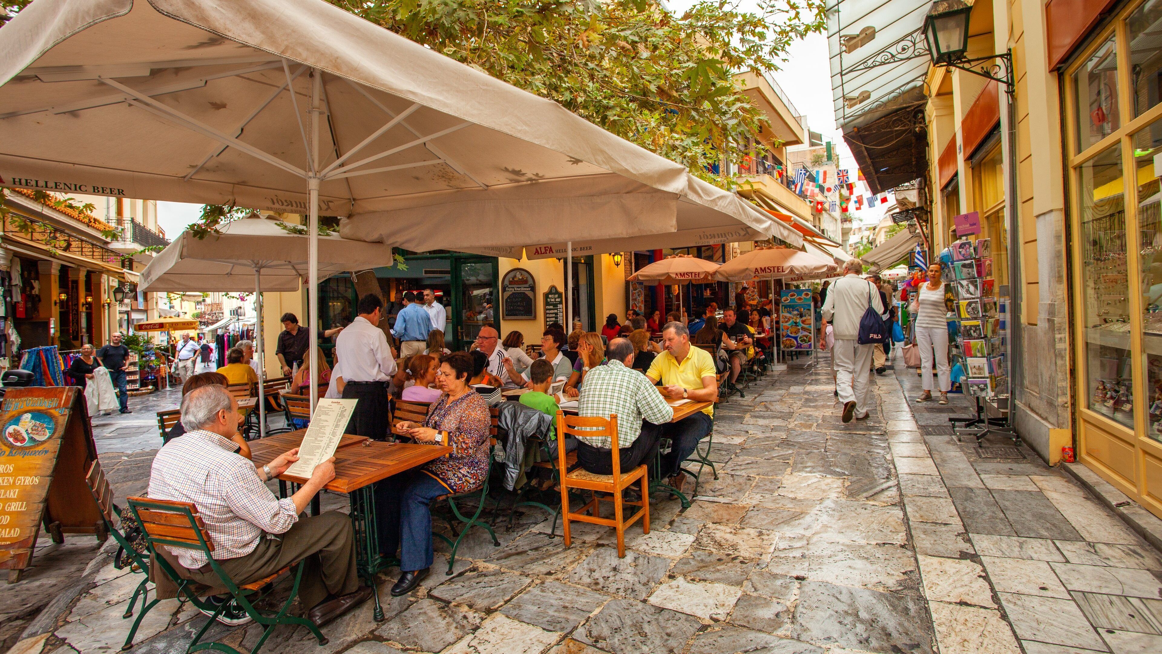 Monastiraki Flea Market which includes outdoor eating and street scenes as well as a small group of people