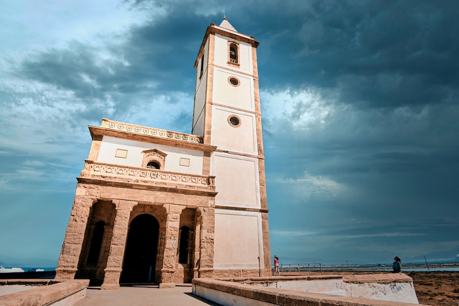 church Las Salinas of Cabo de Gata, built in year 1907, next to the road and the beach in Almadraba de Monteleva (Almeria, Andalusia, Spain, Europe)