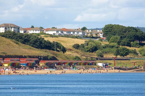 North Bay Beach featuring a coastal town and a beach as well as a large group of people
