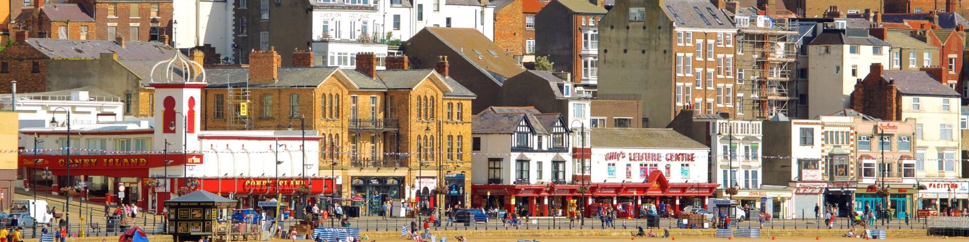 South Bay Beach showing a coastal town and a sandy beach